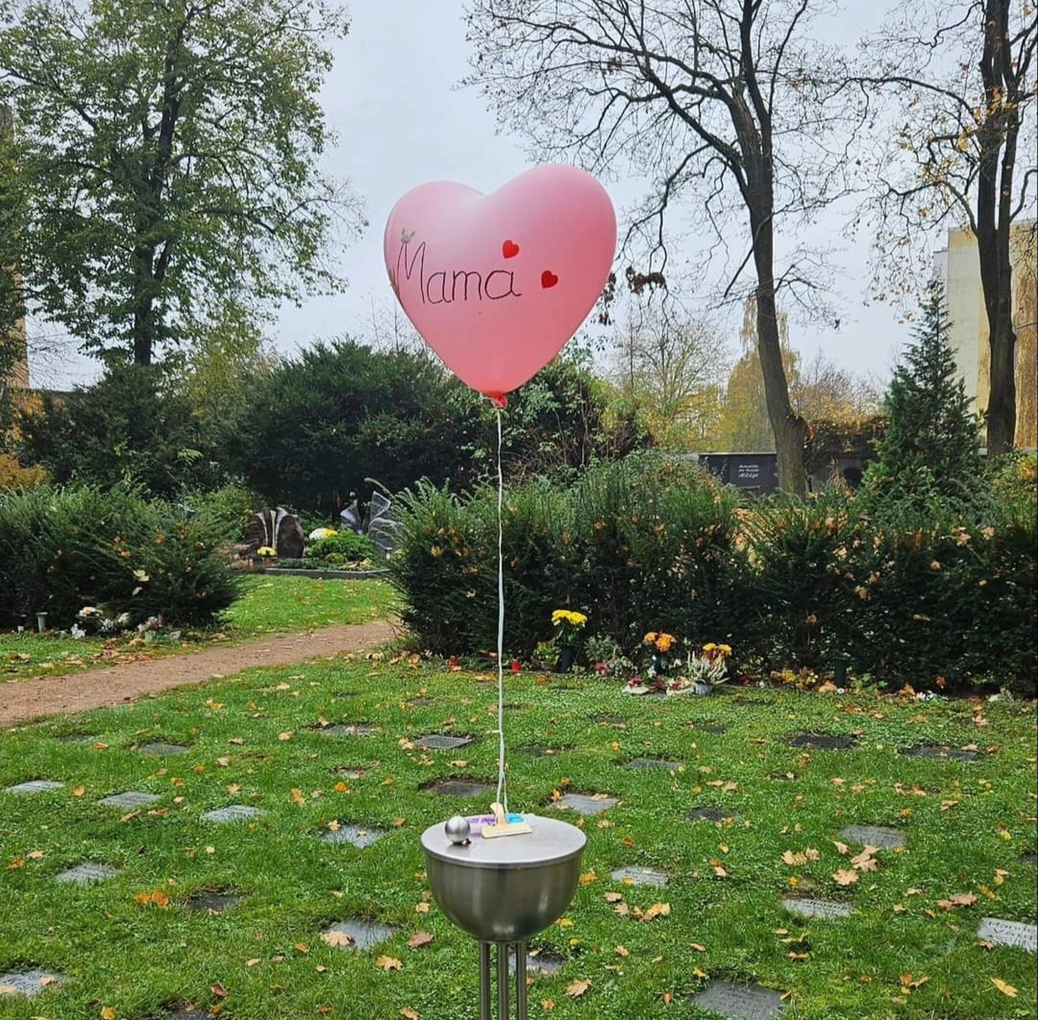 Sarah ENTERTAINMENT - Moment Schauspielerin / Trauerrednerin / Privatdozentin - Ein Ballon war daran befestigt und „Mama“ darauf geschrieben.